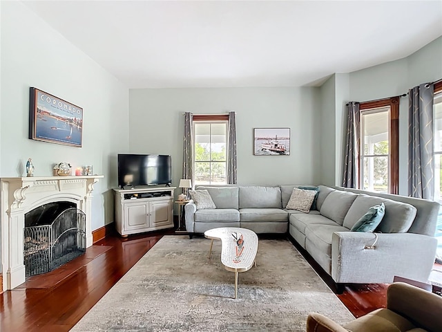 511 E Mirror Lake Dr, Fruitland Park, FL 34731 - living room featuring dark wood-style floors and a fireplace with flush hearth