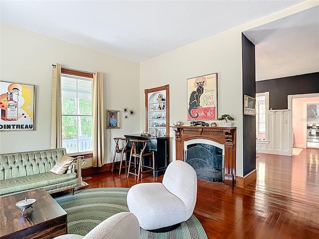 511 E Mirror Lake Dr, Fruitland Park, FL 34731 - living area featuring hardwood / wood-style floors, a fireplace with flush hearth, and baseboards