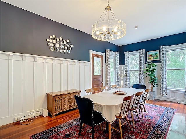511 E Mirror Lake Dr, Fruitland Park, FL 34731 - dining space featuring wood finished floors, a decorative wall, a chandelier, and a wainscoted wall