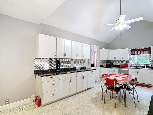 511 E Mirror Lake Dr, Fruitland Park, FL 34731 - kitchen with a sink, dishwasher, ceiling fan, white cabinets, and high vaulted ceiling