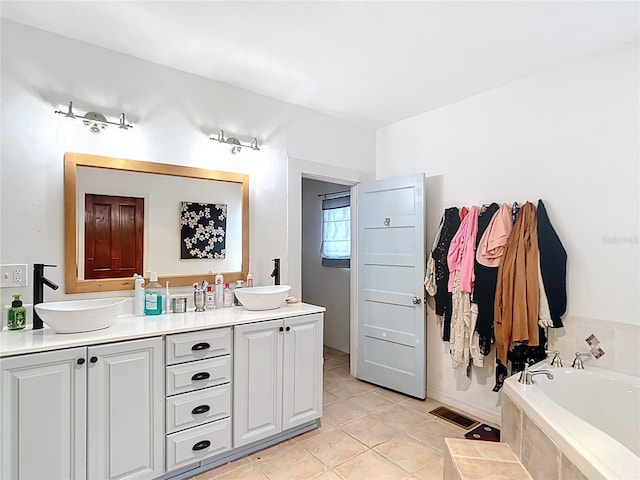 511 E Mirror Lake Dr, Fruitland Park, FL 34731 - full bathroom featuring tile patterned floors, a relaxing tiled tub, and double vanity