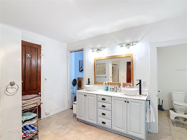 511 E Mirror Lake Dr, Fruitland Park, FL 34731 - full bathroom with double vanity, toilet, and tile patterned floors