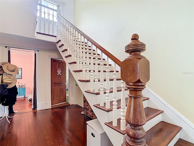 511 E Mirror Lake Dr, Fruitland Park, FL 34731 - staircase with wood-type flooring, baseboards, and a towering ceiling