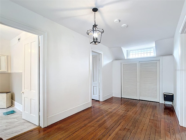 511 E Mirror Lake Dr, Fruitland Park, FL 34731 - bonus room featuring a chandelier, hardwood / wood-style flooring, and baseboards