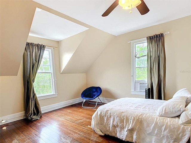 511 E Mirror Lake Dr, Fruitland Park, FL 34731 - bedroom with multiple windows, hardwood / wood-style flooring, lofted ceiling, baseboards, and ceiling fan