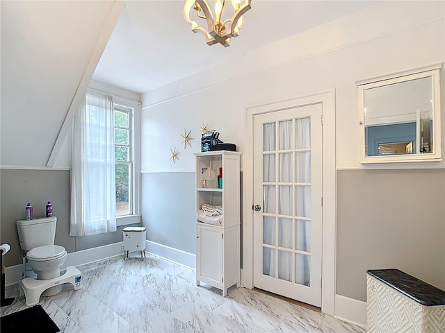 511 E Mirror Lake Dr, Fruitland Park, FL 34731 - bathroom with a chandelier, toilet, marble look tiles, and baseboards