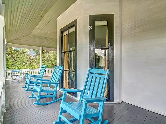511 E Mirror Lake Dr, Fruitland Park, FL 34731 - wooden deck featuring a porch