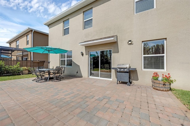 455 Lazio Cir, Debary, FL 32713 - back of house featuring stucco siding, a patio, and fence