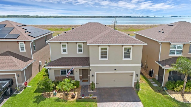 455 Lazio Cir, Debary, FL 32713 - traditional home with stucco siding, driveway, a garage, a shingled roof, and a front lawn