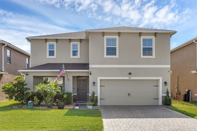 455 Lazio Cir, Debary, FL 32713 - view of front of home with decorative driveway, stucco siding, and a front yard