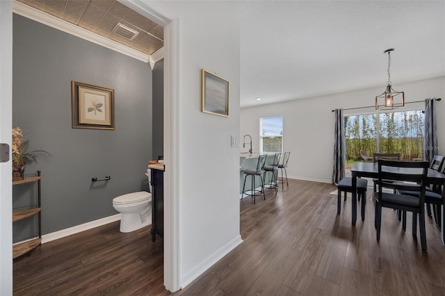455 Lazio Cir, Debary, FL 32713 - dining room featuring dark wood finished floors, baseboards, and crown molding