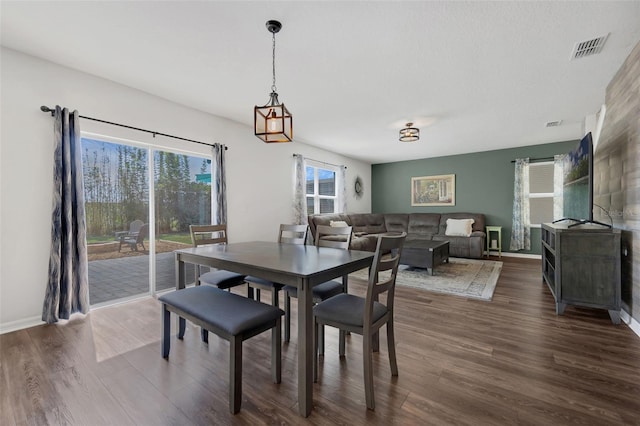455 Lazio Cir, Debary, FL 32713 - dining room featuring plenty of natural light, dark wood-type flooring, and baseboards