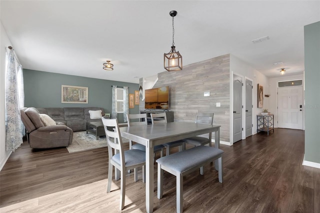 455 Lazio Cir, Debary, FL 32713 - dining area with an accent wall, wood finished floors, baseboards, and wooden walls