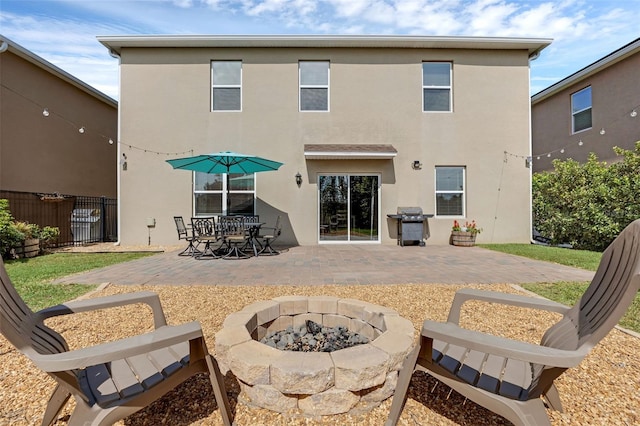 455 Lazio Cir, Debary, FL 32713 - back of house featuring a patio area, an outdoor fire pit, fence, and stucco siding