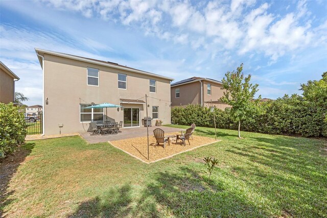 455 Lazio Cir, Debary, FL 32713 - back of house with stucco siding and a patio