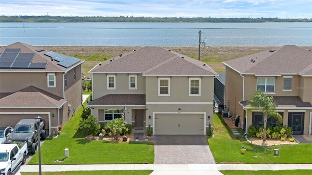455 Lazio Cir, Debary, FL 32713 - view of front of home featuring driveway, stucco siding, central AC, and a water view