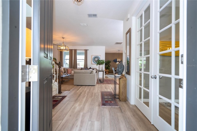 6543 Orange Cream Aly, Winter Garden, FL 34787 - hall with french doors, light wood finished floors, and a chandelier