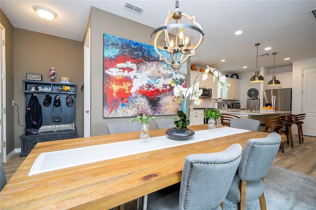 6543 Orange Cream Aly, Winter Garden, FL 34787 - dining room with light wood finished floors, a chandelier, and recessed lighting