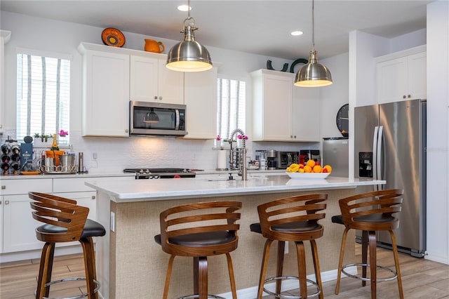 6543 Orange Cream Aly, Winter Garden, FL 34787 - kitchen featuring appliances with stainless steel finishes, a sink, backsplash, white cabinetry, and recessed lighting