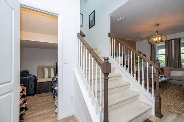 6543 Orange Cream Aly, Winter Garden, FL 34787 - staircase featuring wood finished floors and a chandelier