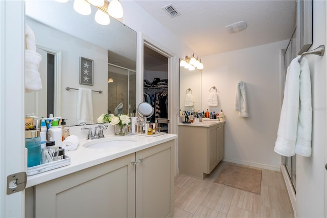 6543 Orange Cream Aly, Winter Garden, FL 34787 - bathroom with a stall shower, a spacious closet, and two vanities