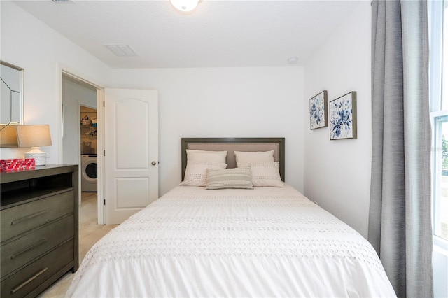 6543 Orange Cream Aly, Winter Garden, FL 34787 - bedroom with washer / dryer and light colored carpet
