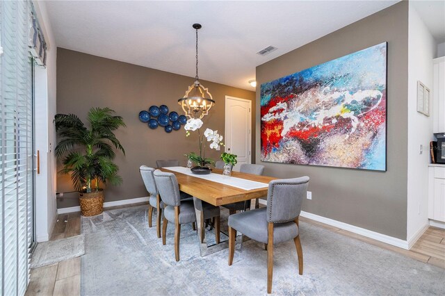 6543 Orange Cream Aly, Winter Garden, FL 34787 - dining room featuring light wood-type flooring, a chandelier, and baseboards