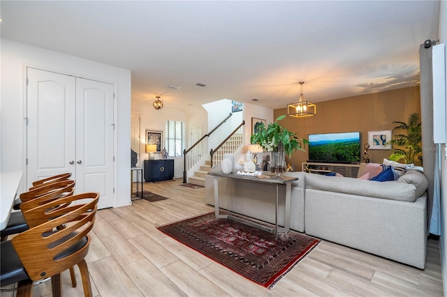 6543 Orange Cream Aly, Winter Garden, FL 34787 - living area with stairs, light wood-style floors, and a chandelier