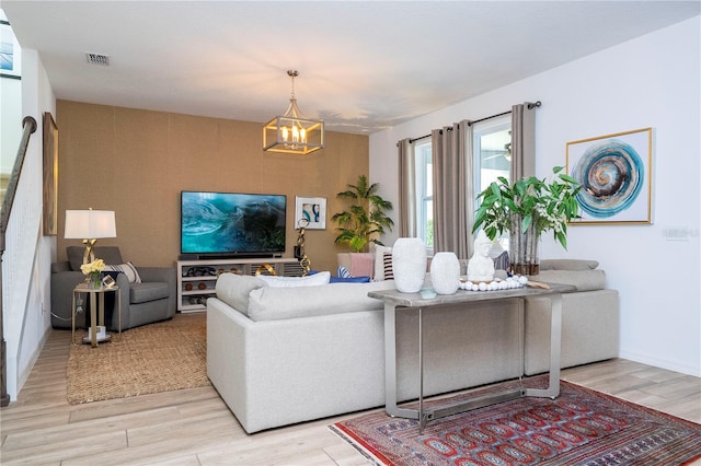 6543 Orange Cream Aly, Winter Garden, FL 34787 - living area featuring light wood-style floors and a chandelier