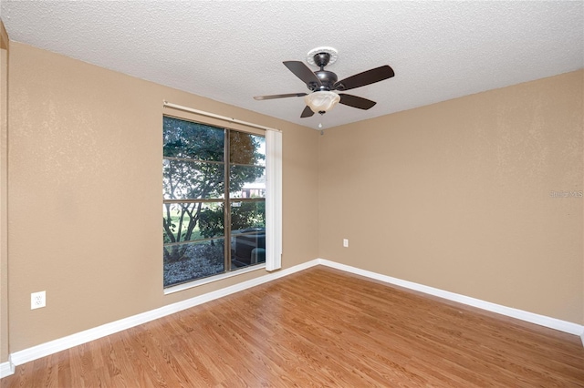 738 Haven Pl, Tarpon Springs, FL 34689 - spare room featuring wood finished floors, baseboards, a ceiling fan, and a textured ceiling