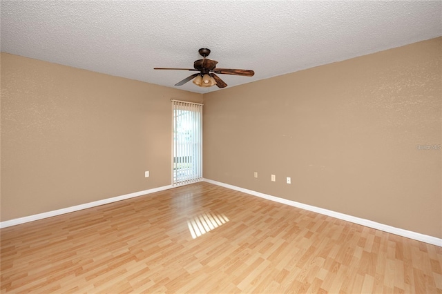 738 Haven Pl, Tarpon Springs, FL 34689 - empty room featuring light wood-style floors, a ceiling fan, baseboards, and a textured ceiling