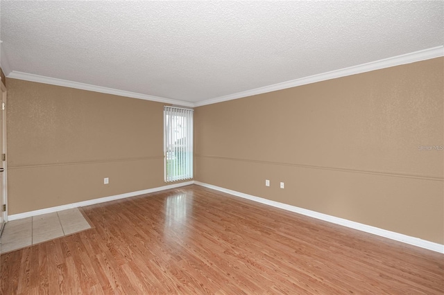738 Haven Pl, Tarpon Springs, FL 34689 - unfurnished room featuring light wood-style floors, a textured ceiling, crown molding, and baseboards