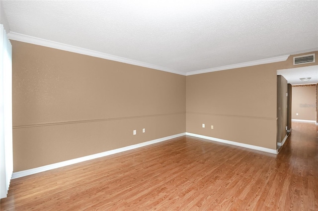 738 Haven Pl, Tarpon Springs, FL 34689 - empty room with wood finished floors, ornamental molding, baseboards, and a textured ceiling