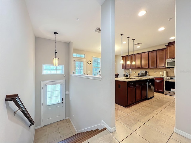 1027 Cedar Bay Ln, Winter Springs, FL 32708 - kitchen featuring appliances with stainless steel finishes, a sink, decorative backsplash, decorative light fixtures, and recessed lighting