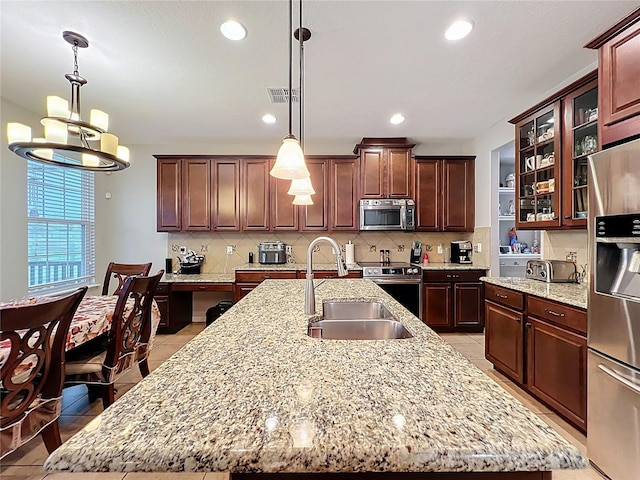1027 Cedar Bay Ln, Winter Springs, FL 32708 - kitchen featuring stainless steel appliances, a sink, an island with sink, tasteful backsplash, and recessed lighting