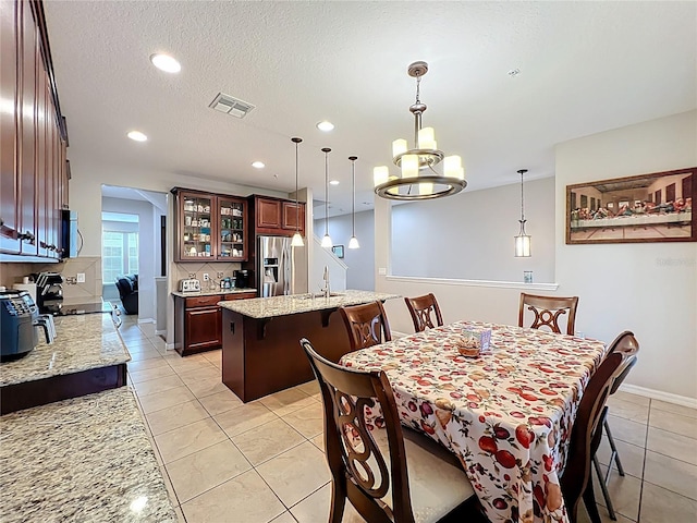 1027 Cedar Bay Ln, Winter Springs, FL 32708 - dining room with light tile patterned floors, a chandelier, recessed lighting, baseboards, and a textured ceiling