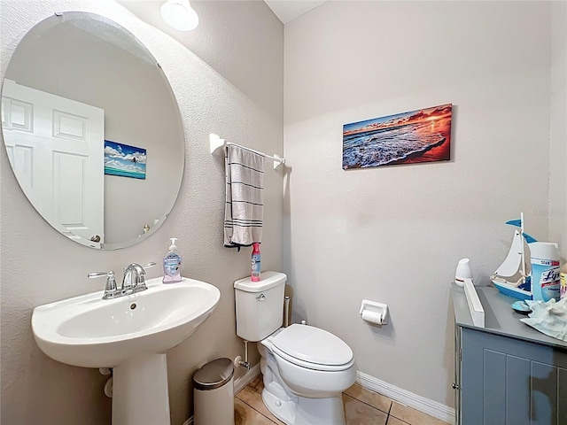 1027 Cedar Bay Ln, Winter Springs, FL 32708 - bathroom featuring tile patterned floors, toilet, baseboards, and a sink