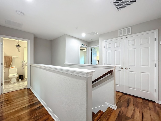 1027 Cedar Bay Ln, Winter Springs, FL 32708 - hallway with an upstairs landing, dark wood-style floors, and baseboards