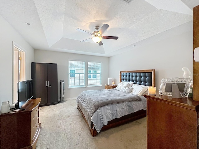 1027 Cedar Bay Ln, Winter Springs, FL 32708 - bedroom featuring a tray ceiling, light colored carpet, a ceiling fan, a textured ceiling, and baseboards