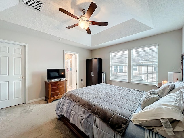1027 Cedar Bay Ln, Winter Springs, FL 32708 - bedroom featuring light carpet, a tray ceiling, baseboards, a ceiling fan, and ensuite bathroom