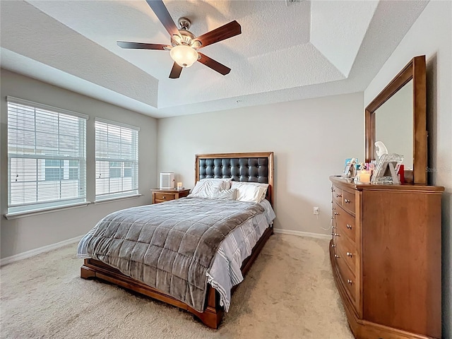1027 Cedar Bay Ln, Winter Springs, FL 32708 - bedroom with light colored carpet, baseboards, a tray ceiling, ceiling fan, and a textured ceiling