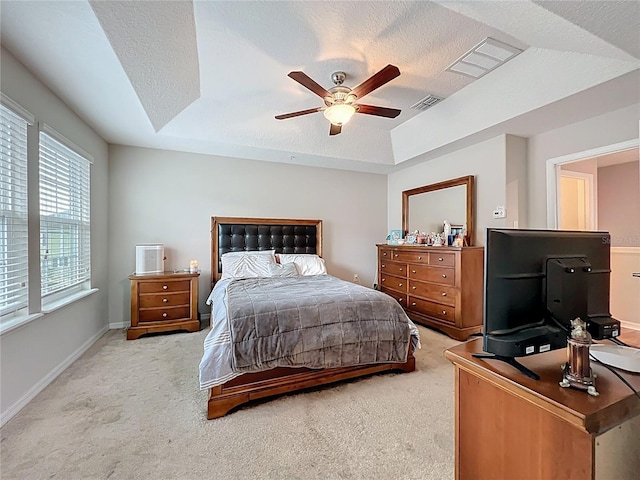 1027 Cedar Bay Ln, Winter Springs, FL 32708 - bedroom featuring a raised ceiling, light carpet, a textured ceiling, a ceiling fan, and baseboards