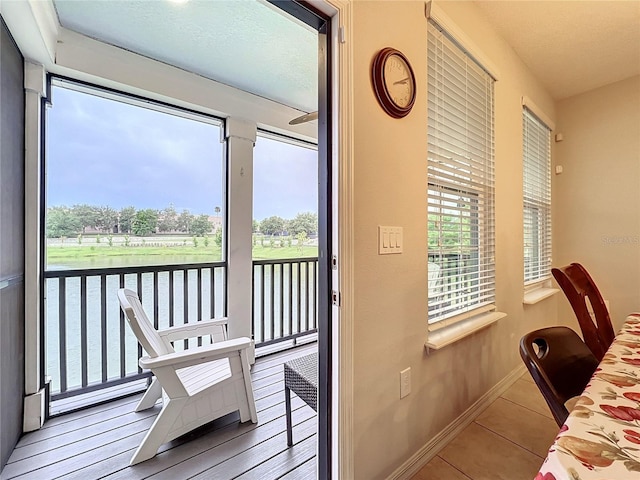 1027 Cedar Bay Ln, Winter Springs, FL 32708 - doorway to outside featuring baseboards, tile patterned flooring, and a water view