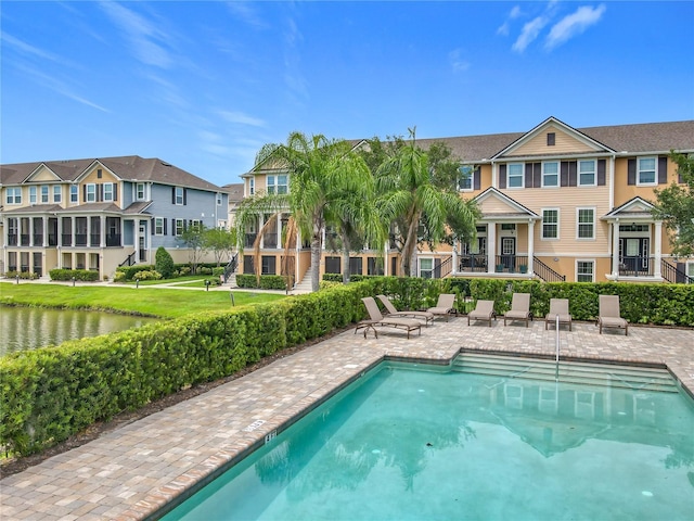1027 Cedar Bay Ln, Winter Springs, FL 32708 - community pool with a patio area, a residential view, stairs, and a water view