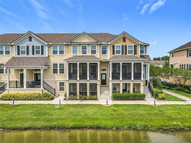 1027 Cedar Bay Ln, Winter Springs, FL 32708 - back of property with stairs, a water view, a sunroom, and stucco siding