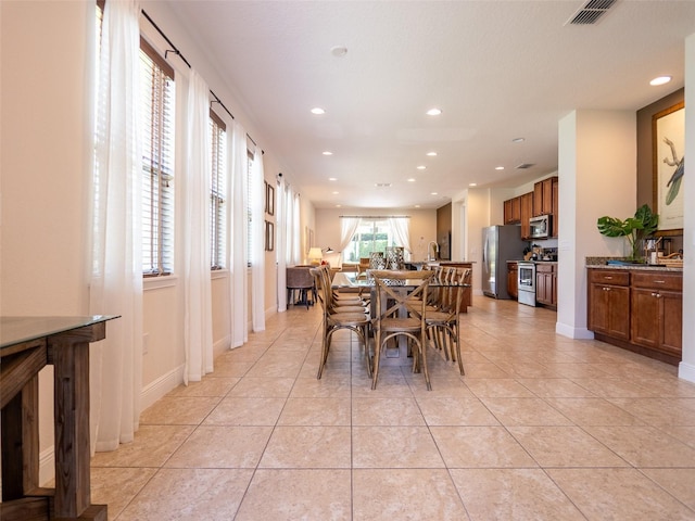 311 W Falls Dr, Kissimmee, FL 34747 - dining space with recessed lighting, light tile patterned floors, and baseboards