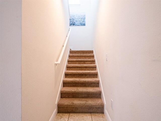 311 W Falls Dr, Kissimmee, FL 34747 - staircase with tile patterned floors and baseboards