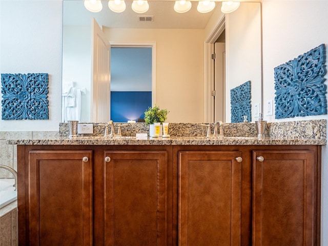 311 W Falls Dr, Kissimmee, FL 34747 - bathroom featuring double vanity and a tub to relax in