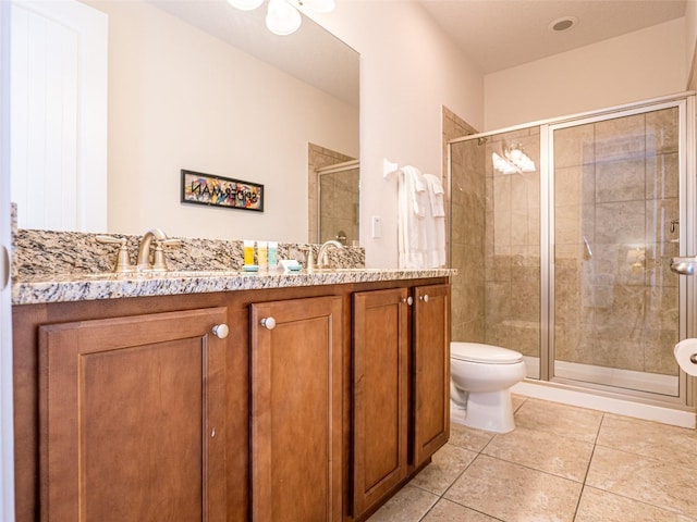 311 W Falls Dr, Kissimmee, FL 34747 - bathroom with a stall shower, tile patterned floors, toilet, and double vanity