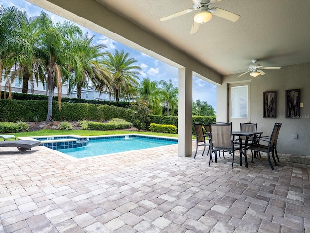 311 W Falls Dr, Kissimmee, FL 34747 - view of swimming pool with a ceiling fan, a patio area, outdoor dining area, and a pool with connected hot tub